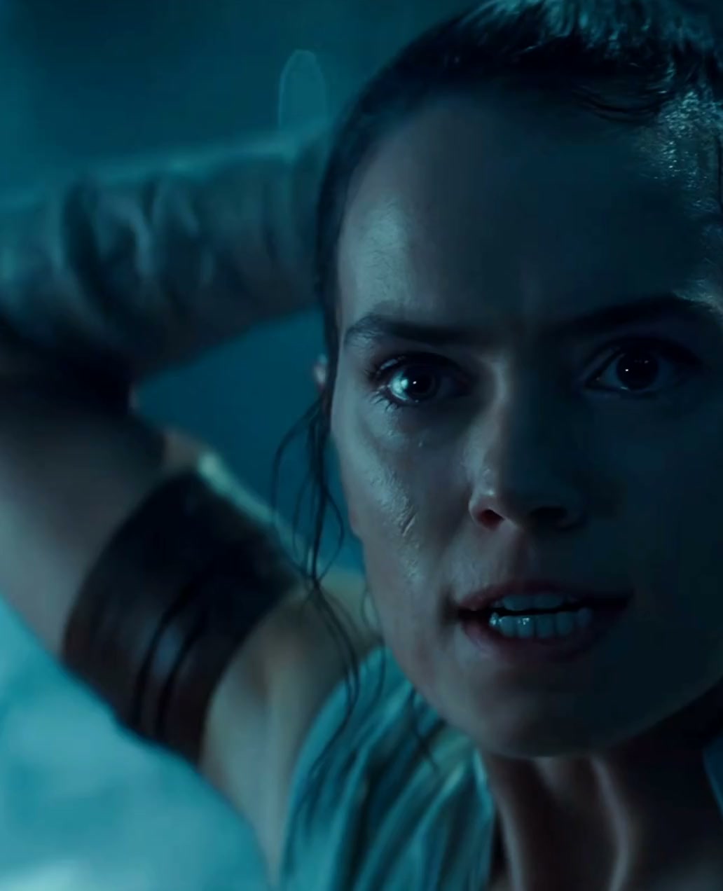 Rey passes a lightsaber through the Force bond